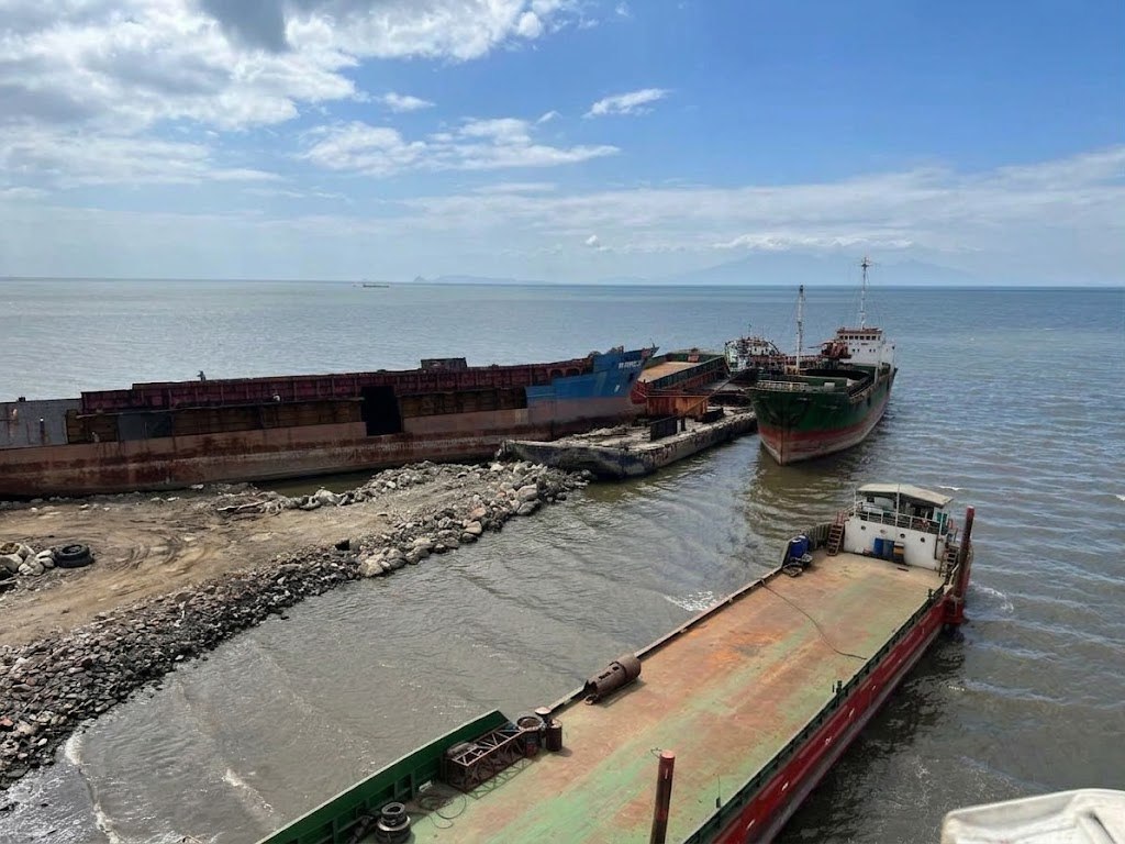 Barges and a cargo vessel moored at the Vistamarine waterfront